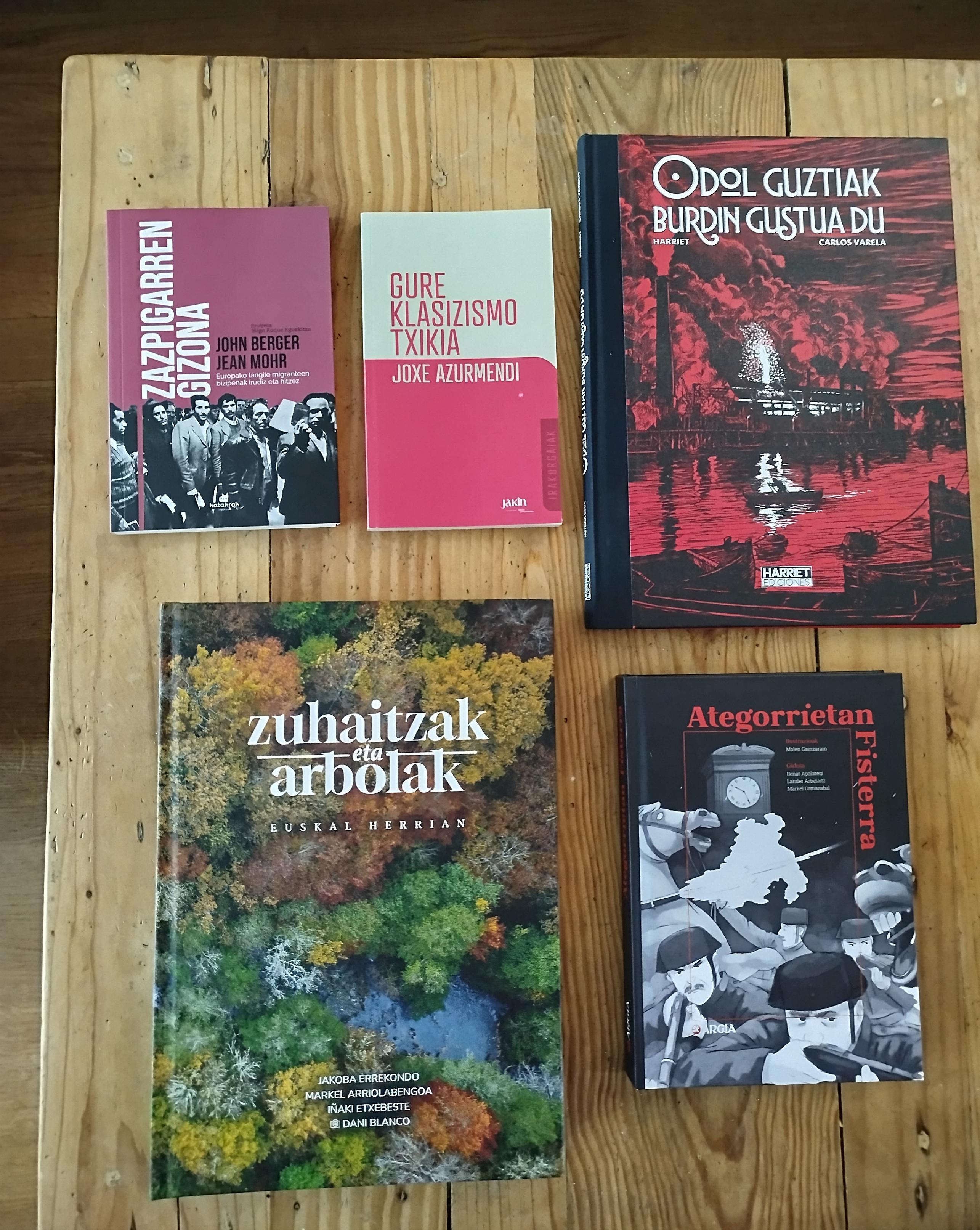 Bost liburu mahai gainean